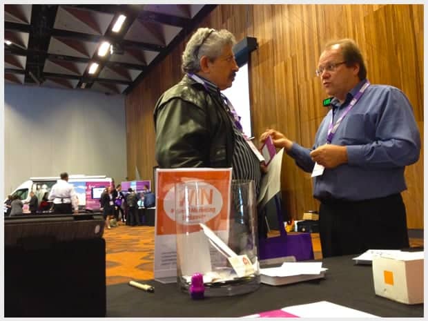 Two attendees talking at the Reach Digital exhibition booth at Small Business BIG Marketing